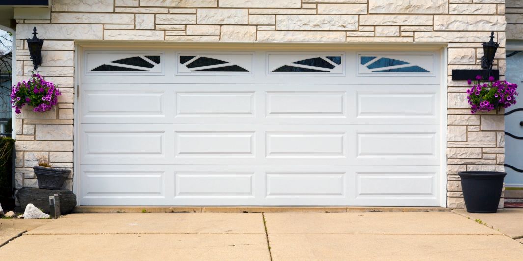 Raised panel overhead door.  Garage door with window inserts. Traditional overhead doors.  Repair.